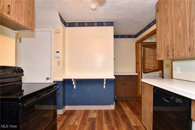 3927 Princeton Blvd, South Euclid, OH 44121 - kitchen with black appliances, dark wood-style floors, baseboards, light countertops, and brown cabinets