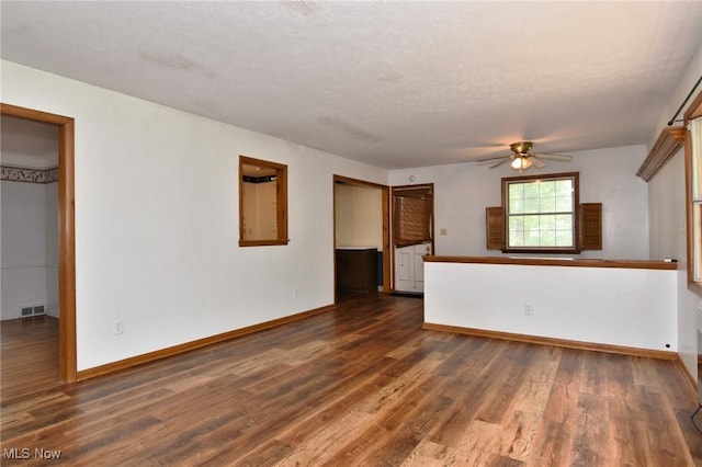 3927 Princeton Blvd, South Euclid, OH 44121 - unfurnished living room featuring ceiling fan, dark wood-style floors, baseboards, and a textured ceiling