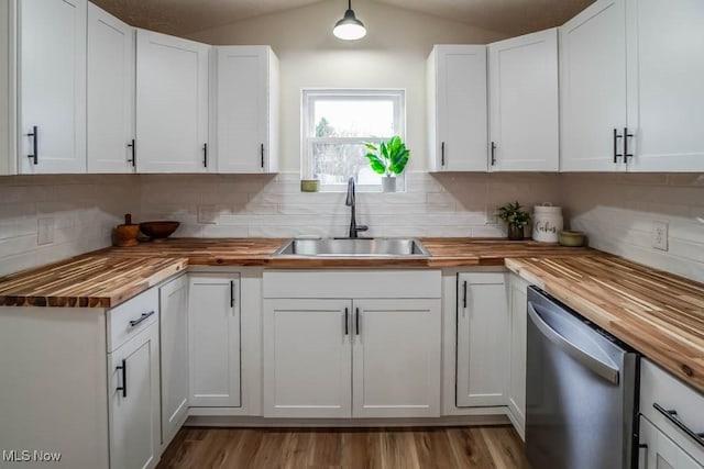 432 Celia Ave, Akron, OH 44312 - kitchen with butcher block counters, stainless steel dishwasher, a sink, backsplash, and white cabinetry