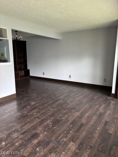 221 Canterbury Unit A38, Medina, OH 44256 - spare room with wood finished floors, baseboards, a chandelier, and a textured ceiling