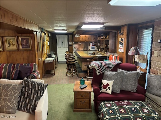 505 Woodside St SW, Hartville, OH 44632 - living area featuring bar area, wood walls, and brick patterned floors