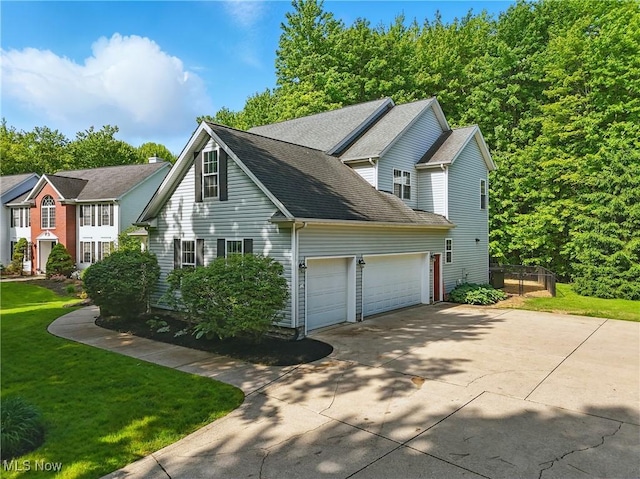7234 Bridlewood Dr, Concord, OH 44077 - view of side of property with concrete driveway, an attached garage, a lawn, and a shingled roof