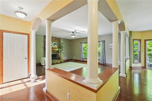 7234 Bridlewood Dr, Concord, OH 44077 - foyer with ceiling fan, plenty of natural light, a fireplace, and dark wood-style flooring