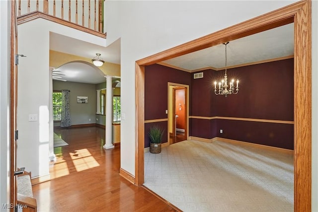 7234 Bridlewood Dr, Concord, OH 44077 - unfurnished dining area featuring ornate columns, arched walkways, wood finished floors, and baseboards