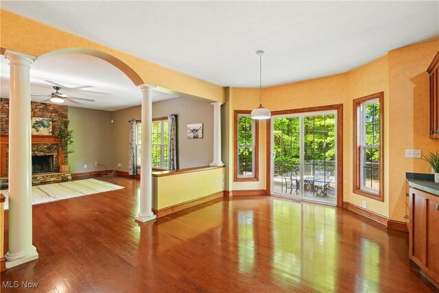 7234 Bridlewood Dr, Concord, OH 44077 - unfurnished dining area with ornate columns, ceiling fan, baseboards, and wood finished floors
