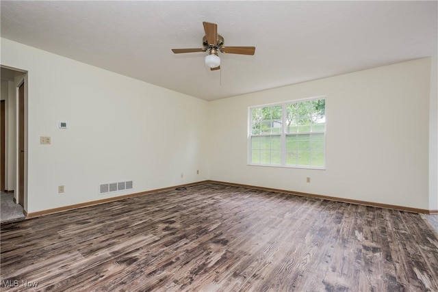 10237 Middlebranch Ave NE, Hartville, OH 44632 - spare room featuring wood finished floors, a ceiling fan, and baseboards