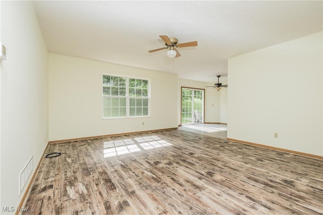 10237 Middlebranch Ave NE, Hartville, OH 44632 - unfurnished room with wood finished floors, a ceiling fan, and baseboards