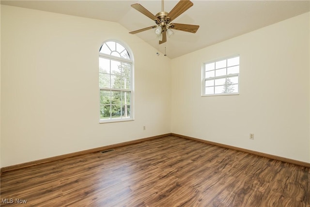 10237 Middlebranch Ave NE, Hartville, OH 44632 - spare room featuring plenty of natural light, wood finished floors, vaulted ceiling, ceiling fan, and baseboards