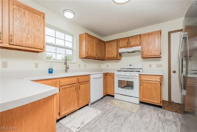 10237 Middlebranch Ave NE, Hartville, OH 44632 - kitchen featuring white appliances, under cabinet range hood, a sink, light wood-style floors, and light countertops