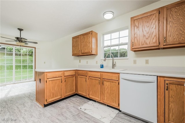 10237 Middlebranch Ave NE, Hartville, OH 44632 - kitchen with dishwasher, a sink, a peninsula, a ceiling fan, and light countertops