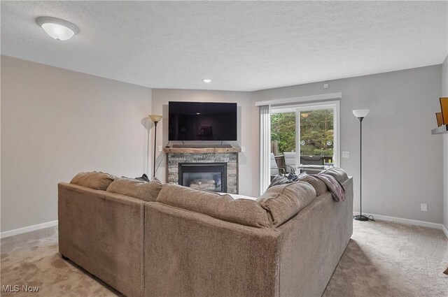 2426 Wrens Dr S, Stow, OH 44224 - living room with light carpet, a stone fireplace, baseboards, and a textured ceiling