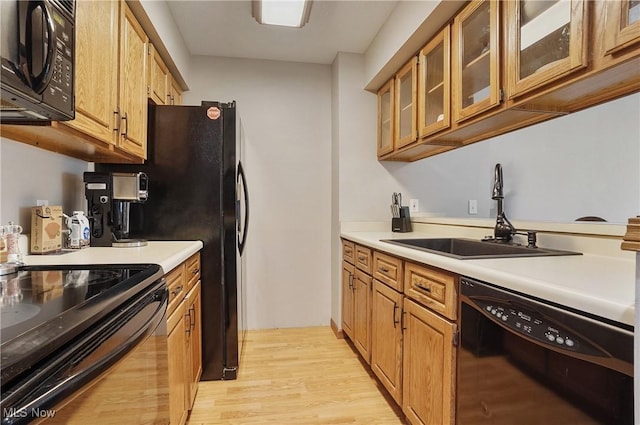 2426 Wrens Dr S, Stow, OH 44224 - kitchen featuring black appliances, a sink, light wood-type flooring, and brown cabinets