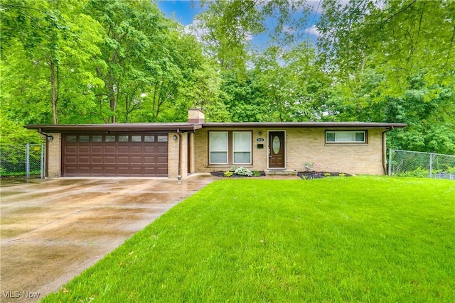1635 Kingsley Ave, Akron, OH 44313 - view of front of property with an attached garage, a chimney, concrete driveway, and brick siding