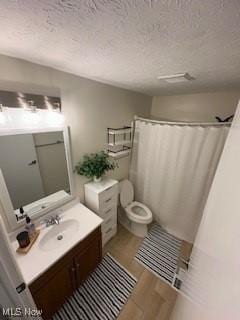 4757 Ledgewood Dr Unit 7-A, Medina, OH 44256 - full bath featuring vanity, a textured ceiling, toilet, wood finished floors, and curtained shower
