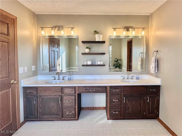 114 Mallard Creek Run, Lagrange, OH 44050 - bathroom with a textured ceiling, double vanity, and tile patterned flooring