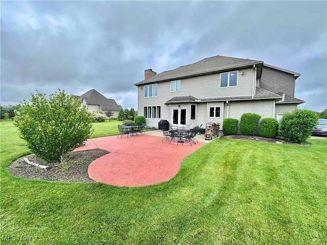 114 Mallard Creek Run, Lagrange, OH 44050 - rear view of property with a chimney, a lawn, and a patio area