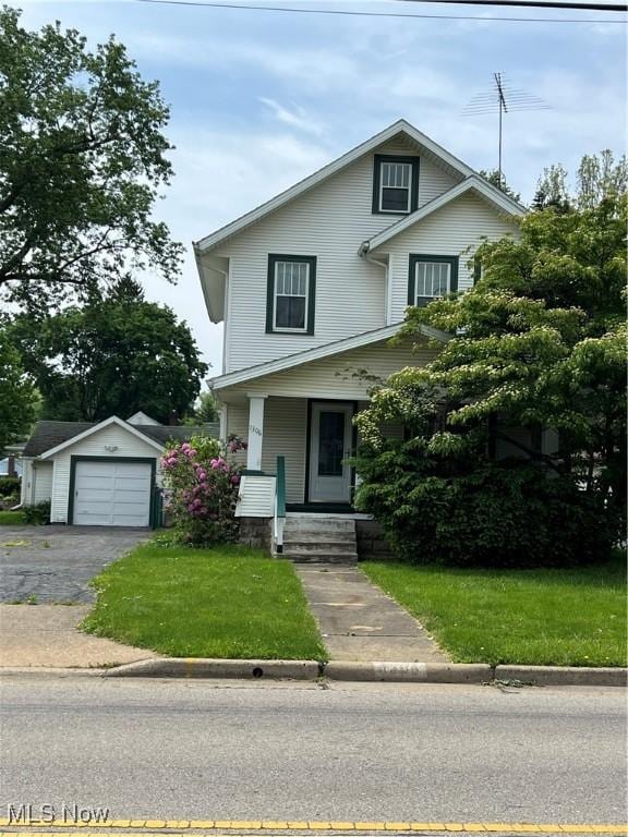 1306 37th St NW, Canton, OH 44709 - view of front facade featuring a detached garage, a front yard, driveway, and covered porch
