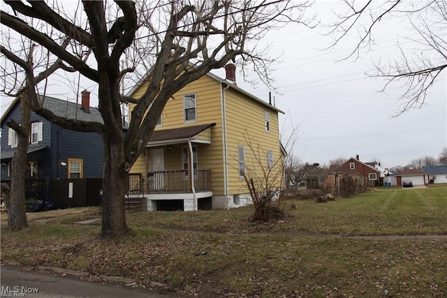3144 Camden Ave, Lorain, OH 44055 - view of home's exterior featuring a porch, a chimney, and a yard