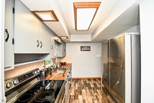 3364 Cormany Rd, Akron, OH 44319 - kitchen with appliances with stainless steel finishes, decorative backsplash, dark wood finished floors, and a sink