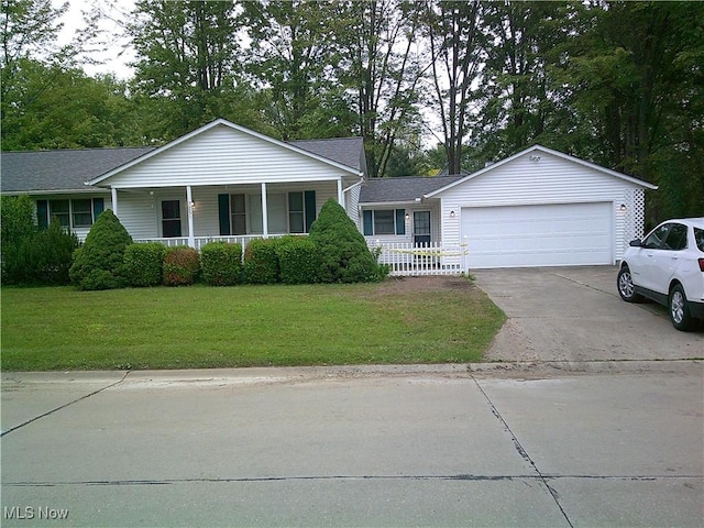 7251 Hidden Glen Dr, Amherst, OH 44001 - ranch-style home with covered porch, a front yard, concrete driveway, and an attached garage