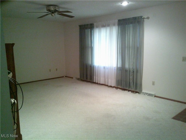 7251 Hidden Glen Dr, Amherst, OH 44001 - empty room with light carpet, a ceiling fan, and baseboards