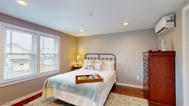 1226 16th St, Parkersburg, WV 26101 - bedroom featuring a wall mounted air conditioner, wood finished floors, baseboards, and recessed lighting