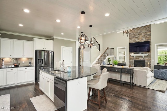 30 Harvester Dr, Copley, OH 44321 - kitchen featuring a sink, stainless steel appliances, open floor plan, a breakfast bar area, and dark wood-type flooring