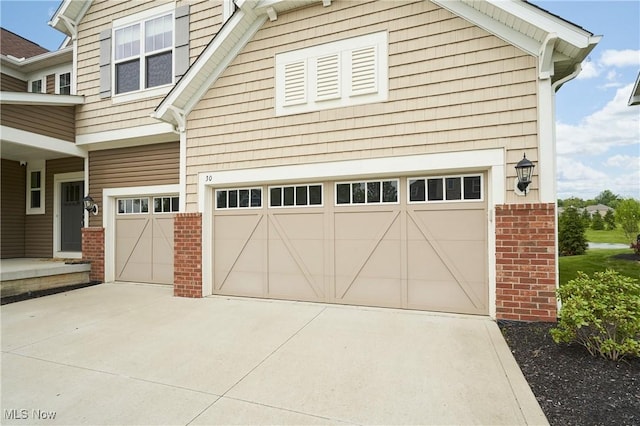 30 Harvester Dr, Copley, OH 44321 - view of front facade featuring brick siding, an attached garage, and concrete driveway