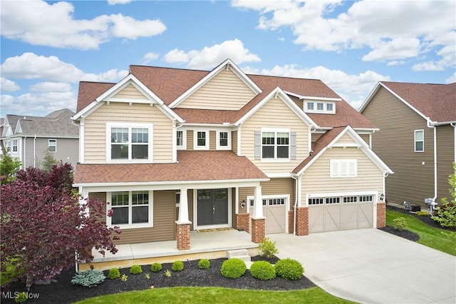 30 Harvester Dr, Copley, OH 44321 - craftsman-style house with covered porch, a garage, driveway, and a shingled roof