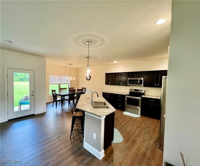 261 Valley View Dr, Weirton, WV 26062 - kitchen with appliances with stainless steel finishes, a sink, dark wood-style flooring, a breakfast bar, and hanging light fixtures