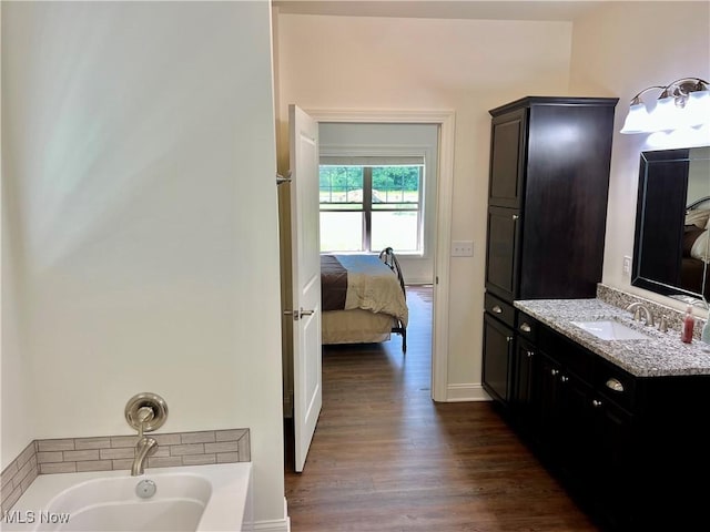 261 Valley View Dr, Weirton, WV 26062 - bathroom with connected bathroom, a bath, vanity, wood finished floors, and baseboards