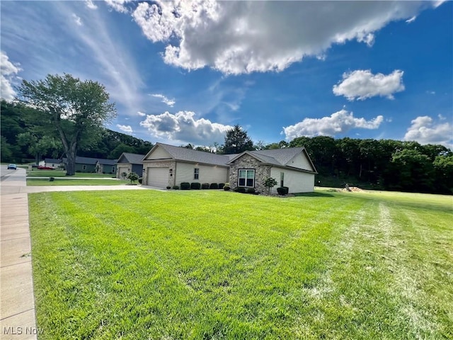 261 Valley View Dr, Weirton, WV 26062 - view of property exterior featuring an attached garage, a lawn, stone siding, and driveway