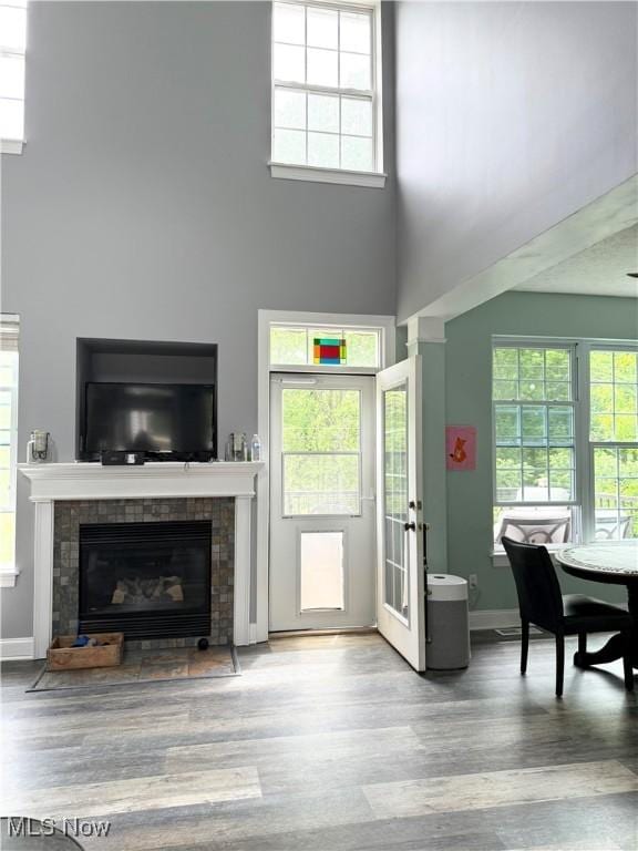 73 Falls River Dr Unit 6, Munroe Falls, OH 44262 - living area with a high ceiling, wood finished floors, a fireplace, and healthy amount of natural light