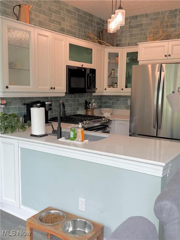 73 Falls River Dr Unit 6, Munroe Falls, OH 44262 - kitchen featuring stainless steel appliances, light countertops, decorative backsplash, and white cabinets
