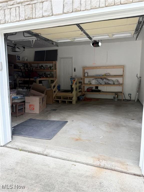 73 Falls River Dr Unit 6, Munroe Falls, OH 44262 - garage with a workshop area and a garage door opener