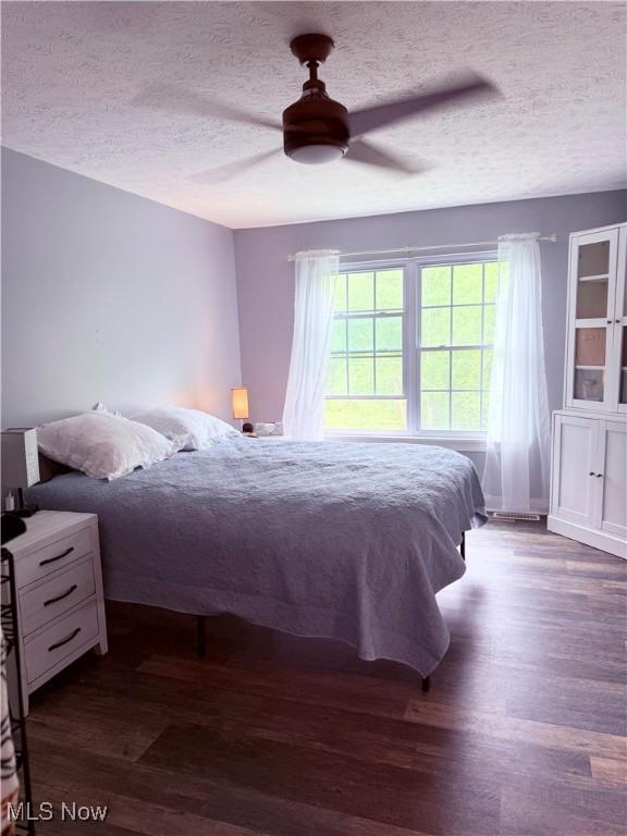 73 Falls River Dr Unit 6, Munroe Falls, OH 44262 - bedroom with a textured ceiling, wood finished floors, and a ceiling fan