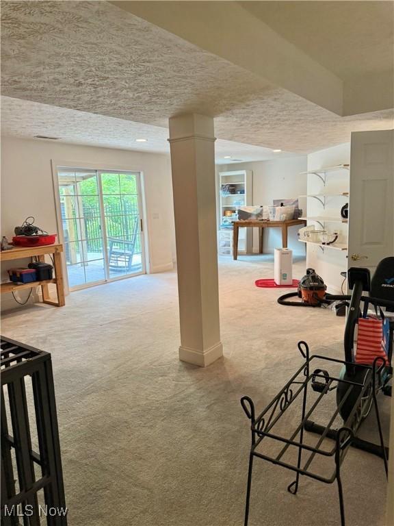 73 Falls River Dr Unit 6, Munroe Falls, OH 44262 - carpeted dining space with a textured ceiling and ornate columns