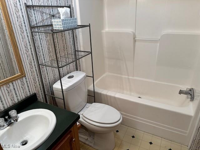 1569 Bogie Ln, Painesville, OH 44077 - bathroom featuring vanity, toilet, bathtub / shower combination, and tile patterned flooring