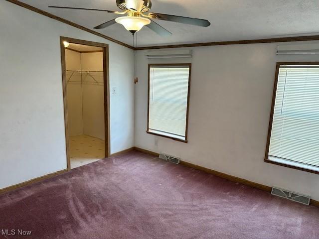 1569 Bogie Ln, Painesville, OH 44077 - unfurnished bedroom featuring ornamental molding, carpet floors, multiple windows, and baseboards