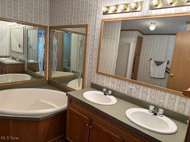 1569 Bogie Ln, Painesville, OH 44077 - full bath with wallpapered walls, a garden tub, double vanity, and a stall shower