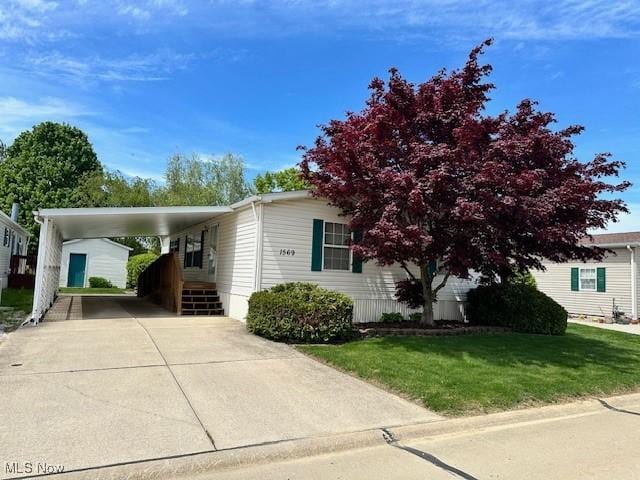 1569 Bogie Ln, Painesville, OH 44077 - view of front of home featuring driveway, a front yard, and a carport