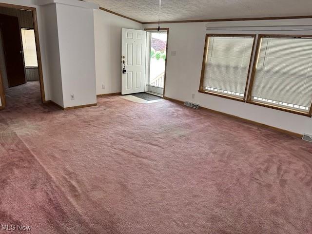 1569 Bogie Ln, Painesville, OH 44077 - carpeted spare room featuring baseboards, a textured ceiling, and ornamental molding