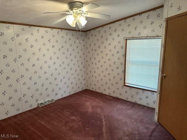 1569 Bogie Ln, Painesville, OH 44077 - spare room featuring wallpapered walls, ornamental molding, carpet floors, and a ceiling fan