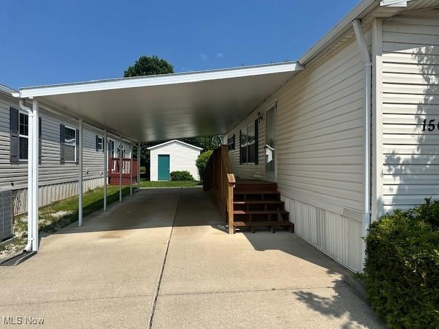 1569 Bogie Ln, Painesville, OH 44077 - view of parking with an attached carport and driveway