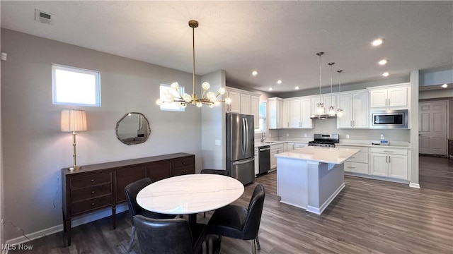 8099 Brookview Ln, Mentor, OH 44060 - kitchen with stainless steel appliances, white cabinetry, light countertops, and recessed lighting