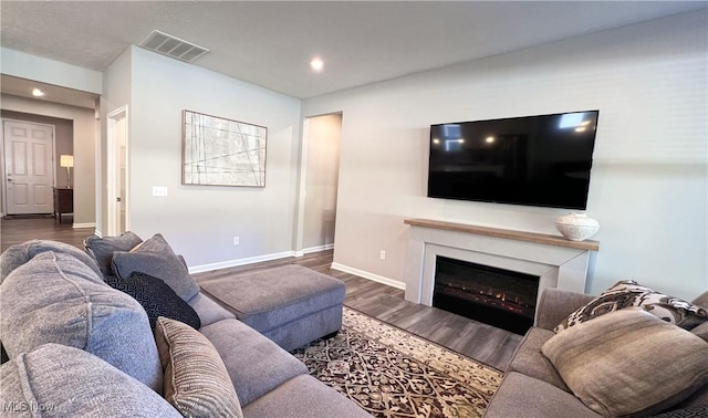 8099 Brookview Ln, Mentor, OH 44060 - living room featuring recessed lighting, wood finished floors, and a glass covered fireplace
