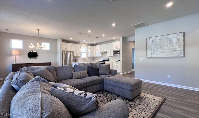 8099 Brookview Ln, Mentor, OH 44060 - living area featuring a chandelier, dark wood-style floors, and recessed lighting