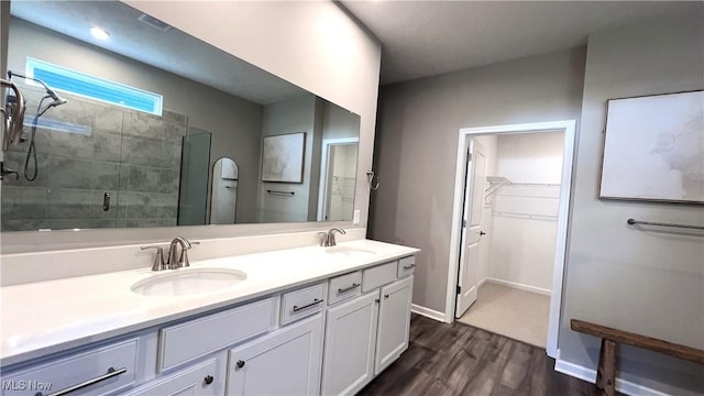 8099 Brookview Ln, Mentor, OH 44060 - bathroom with wood finished floors, double vanity, a spacious closet, and a stall shower