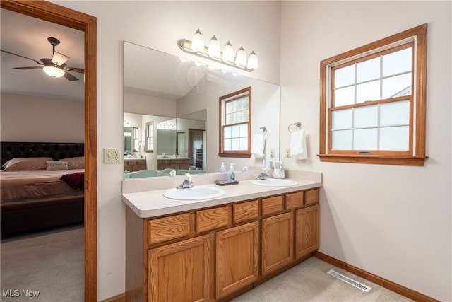 8373 Forest View Dr, Olmsted Falls, OH 44138 - ensuite bathroom featuring double vanity, ceiling fan, and baseboards