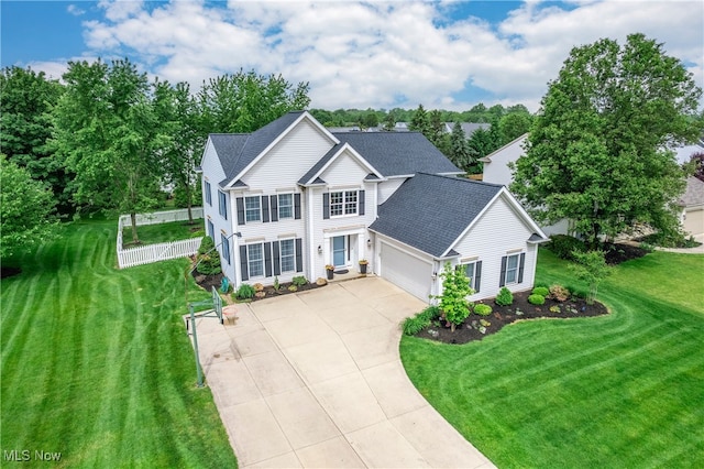 8373 Forest View Dr, Olmsted Falls, OH 44138 - view of front of home featuring roof with shingles, a garage, driveway, and view of scattered trees